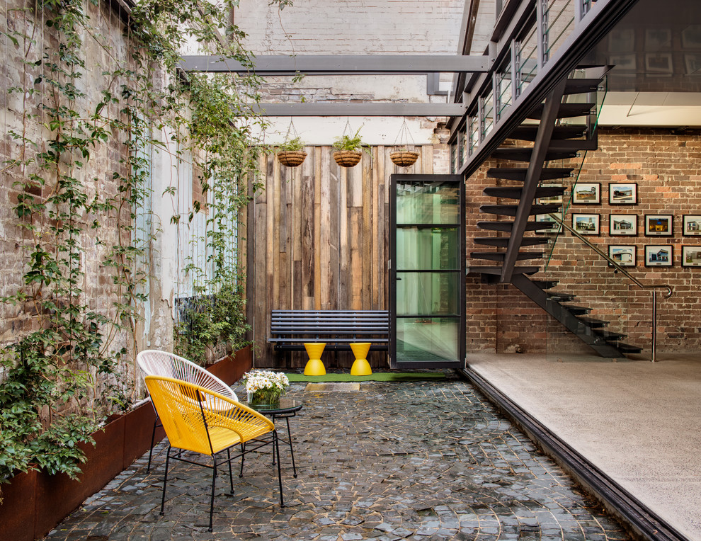 Inspiration for a small industrial side yard patio in Sydney with no cover and a vertical garden.
