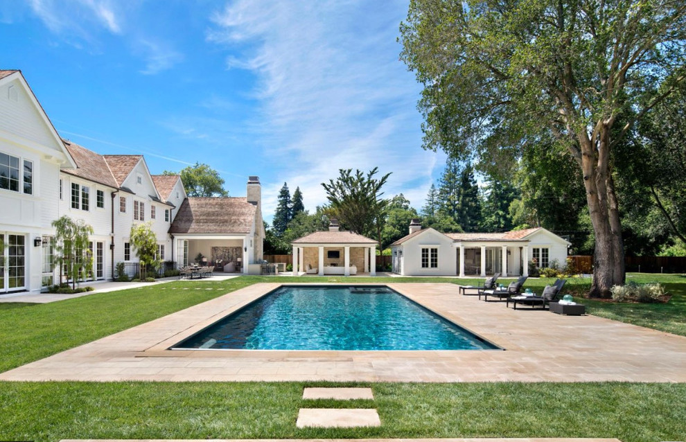 Design ideas for a transitional backyard rectangular pool in Other with a pool house.