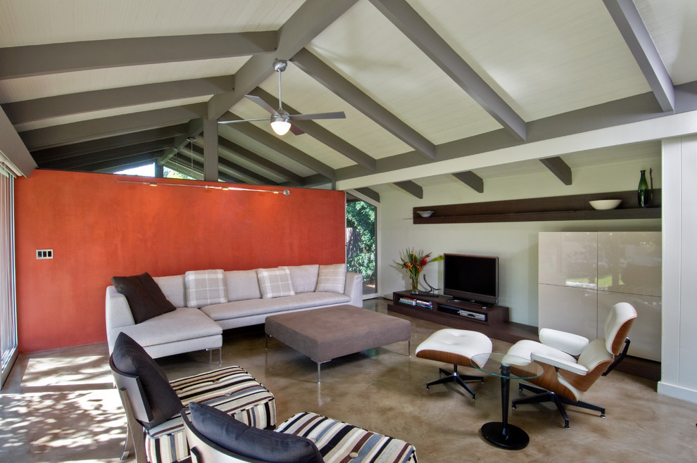 This is an example of a contemporary family room in Hawaii with concrete floors.