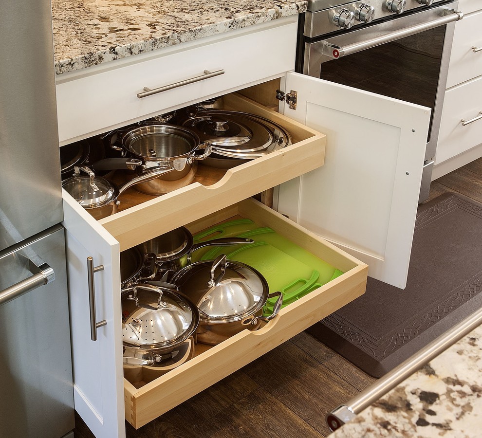 Small single-wall kitchen photo with flat-panel cabinets, white cabinets, stainless steel appliances and an island