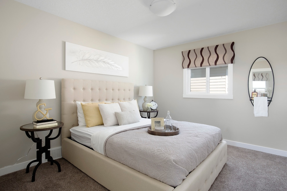 Inspiration for a mid-sized contemporary guest bedroom in Calgary with beige walls and carpet.