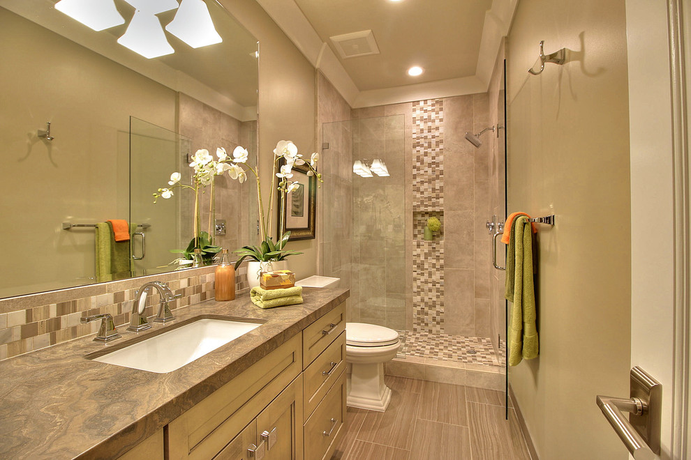 Inspiration for a mid-sized transitional 3/4 bathroom in San Francisco with recessed-panel cabinets, beige cabinets, an alcove shower, a two-piece toilet, multi-coloured tile, mosaic tile, beige walls, laminate floors, an undermount sink, onyx benchtops, beige floor and a hinged shower door.