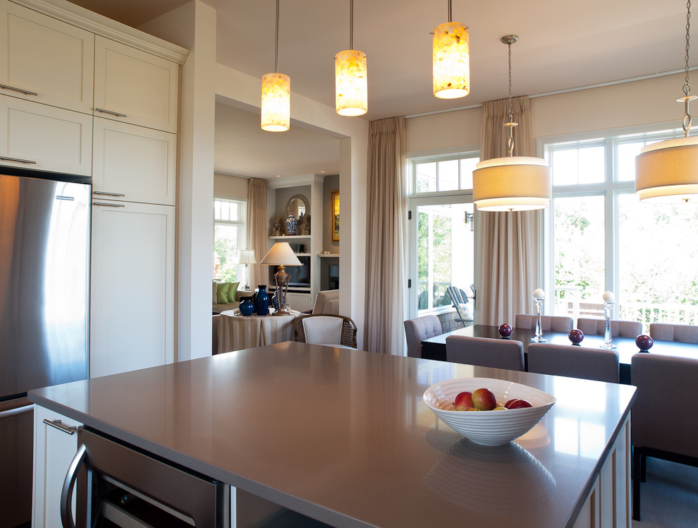 Transitional u-shaped dark wood floor eat-in kitchen photo with recessed-panel cabinets, white cabinets, stainless steel appliances and an island