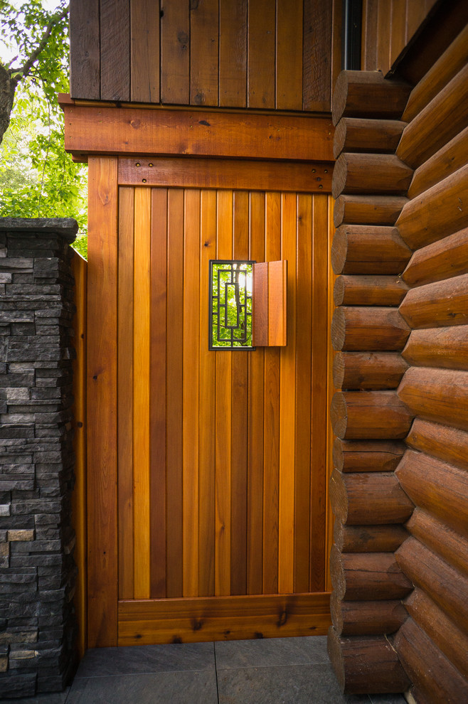 Example of a mountain style backyard deck design in Calgary