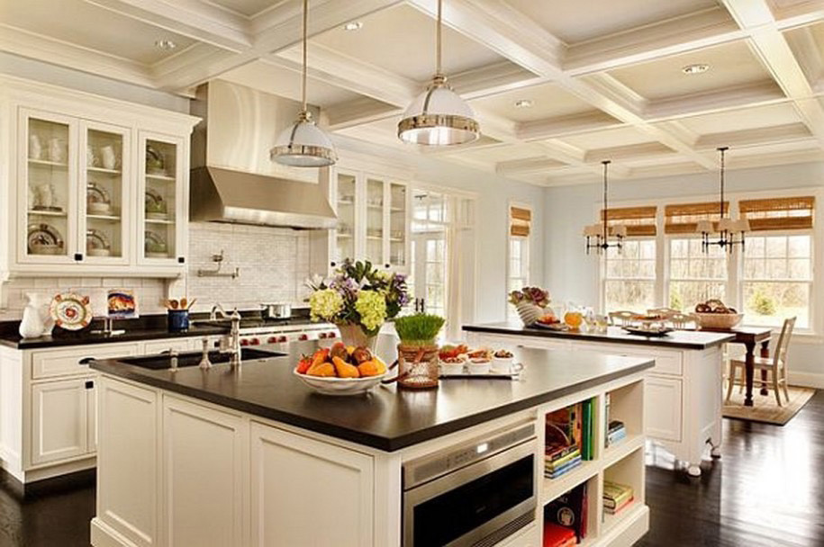 Inspiration for a mid-sized transitional u-shaped kitchen remodel in Toronto with an undermount sink, raised-panel cabinets, white cabinets, stainless steel appliances and an island
