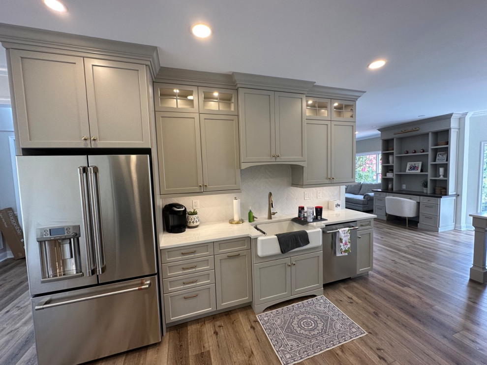 Eat-in kitchen - mid-sized transitional galley vinyl floor and beige floor eat-in kitchen idea in Philadelphia with a farmhouse sink, shaker cabinets, gray cabinets, quartz countertops, white backsplash, ceramic backsplash, stainless steel appliances, an island and white countertops