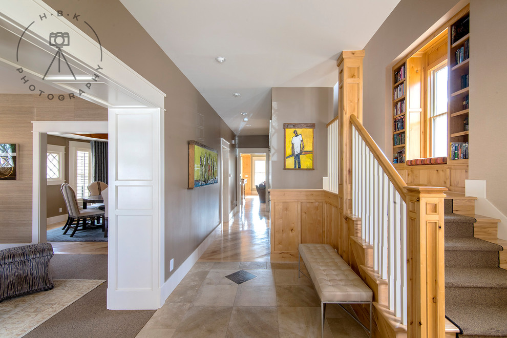 Example of a large porcelain tile and brown floor foyer design with brown walls