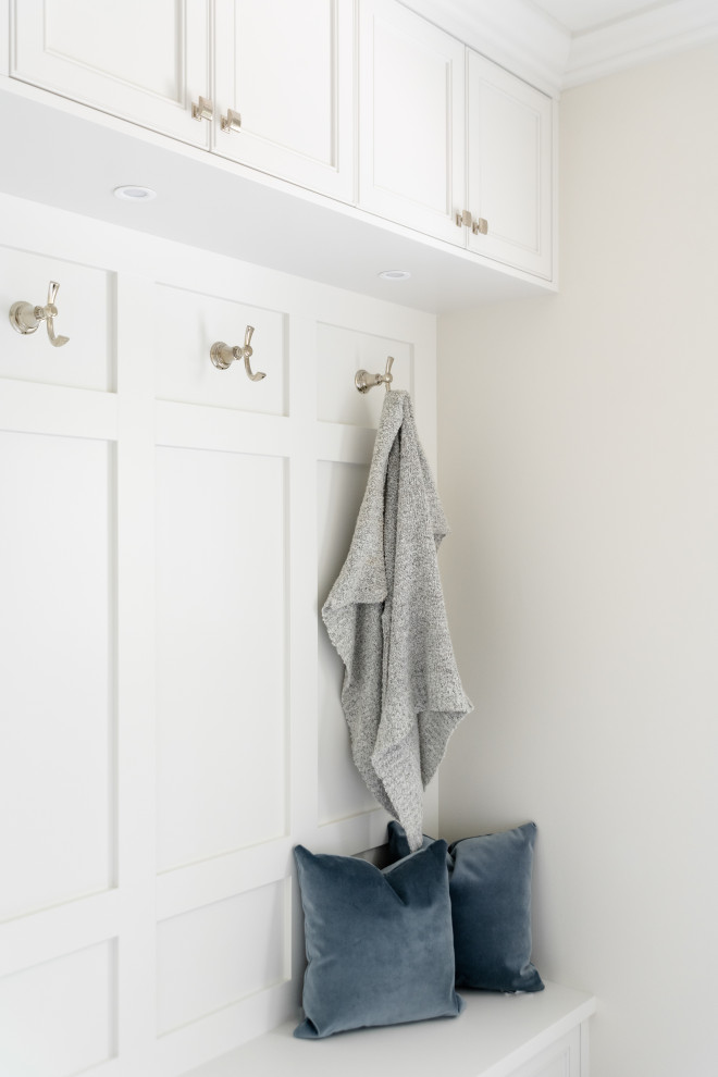 Example of a mid-sized transitional porcelain tile and white floor mudroom design in Vancouver with white walls and a white front door