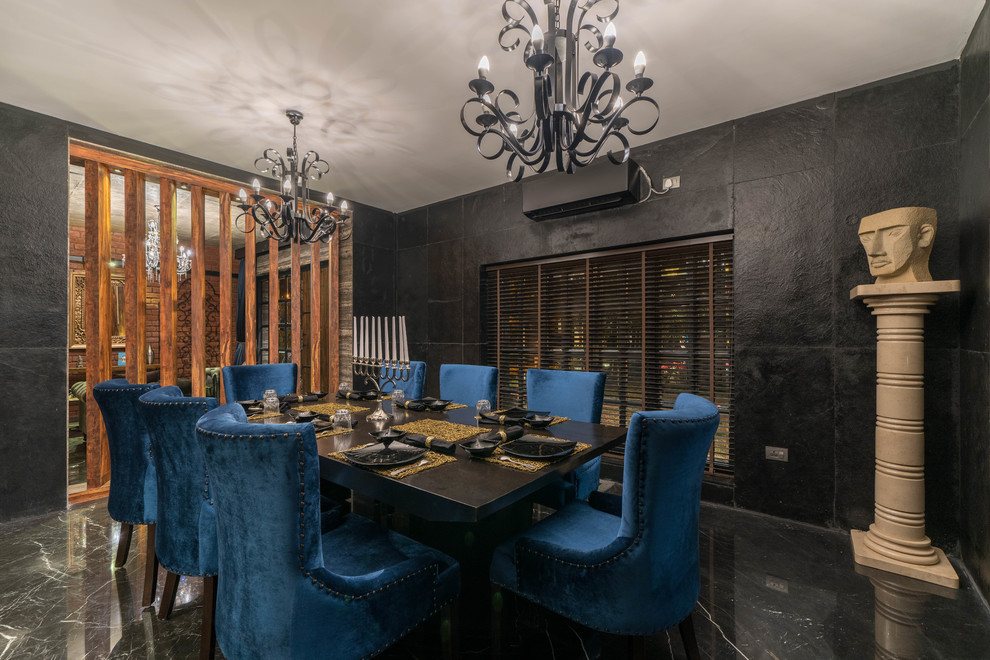 This is an example of a large eclectic dining room in Hyderabad with black walls, marble floors and black floor.