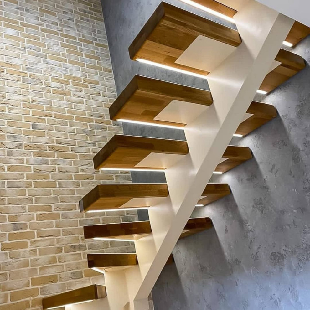 Medium sized rural wood u-shaped staircase in Moscow with wood risers.