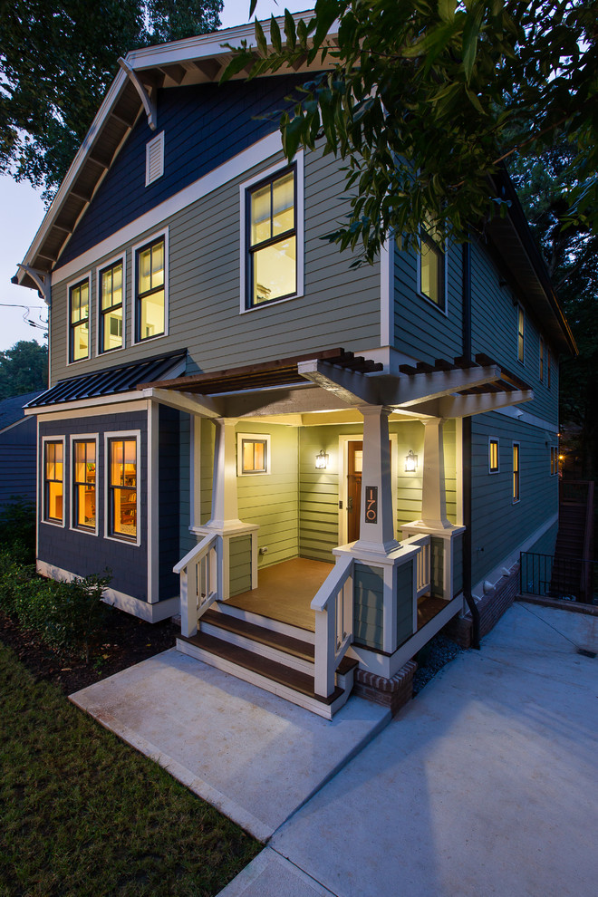 Photo of a mid-sized arts and crafts front yard verandah in Atlanta with a roof extension.