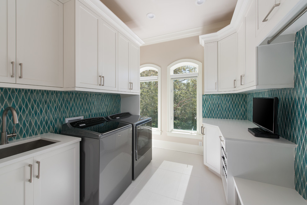 This is an example of a transitional laundry room in Tampa.