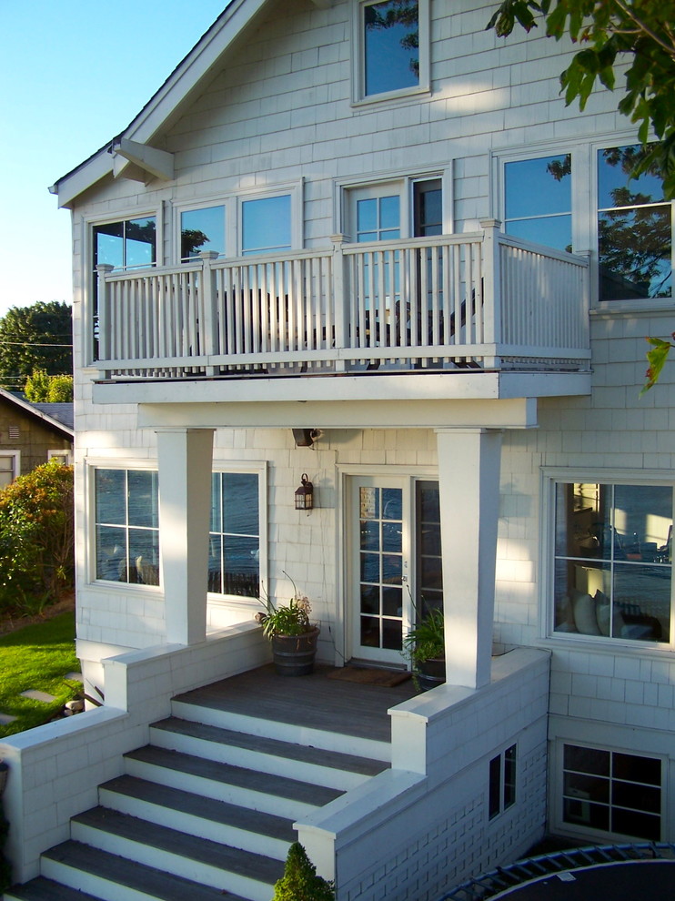 Design ideas for a mid-sized beach style two-storey white exterior in Seattle with wood siding and a gable roof.