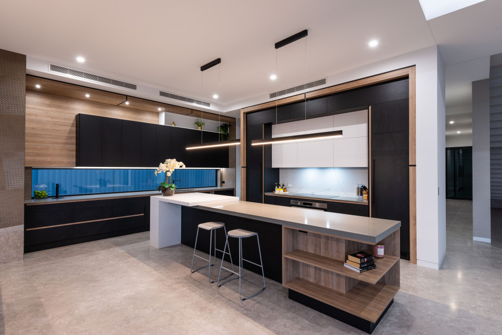 Photo of a contemporary l-shaped open plan kitchen in Gold Coast - Tweed with an undermount sink, flat-panel cabinets, black cabinets, white splashback, concrete floors, with island, grey floor and grey benchtop.