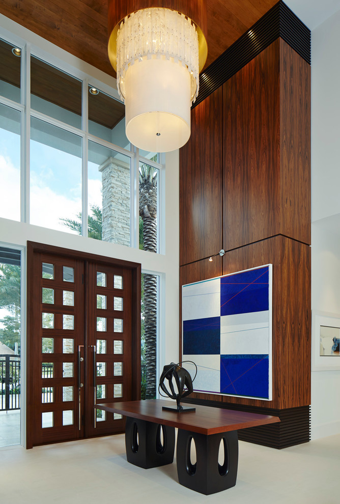Contemporary entryway in Miami with limestone floors, a double front door and a dark wood front door.