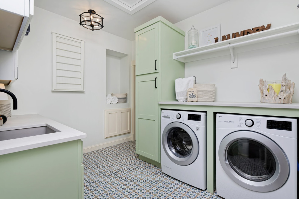 Large trendy l-shaped ceramic tile dedicated laundry room photo in Santa Barbara with an undermount sink, shaker cabinets, white cabinets, white walls and a side-by-side washer/dryer