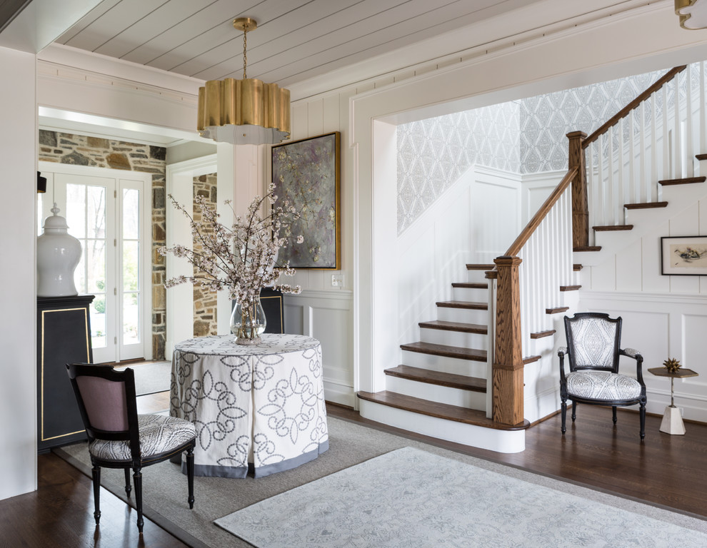 This is an example of a traditional entry hall in DC Metro with white walls and dark hardwood floors.