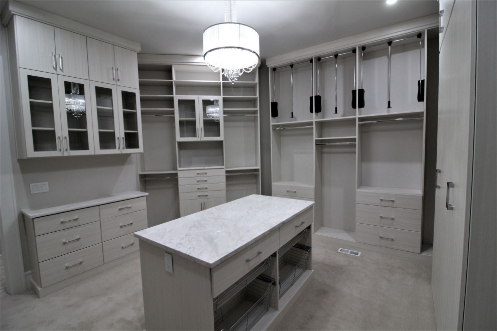 Design ideas for a large transitional women's walk-in wardrobe in Indianapolis with glass-front cabinets, beige cabinets, carpet and beige floor.