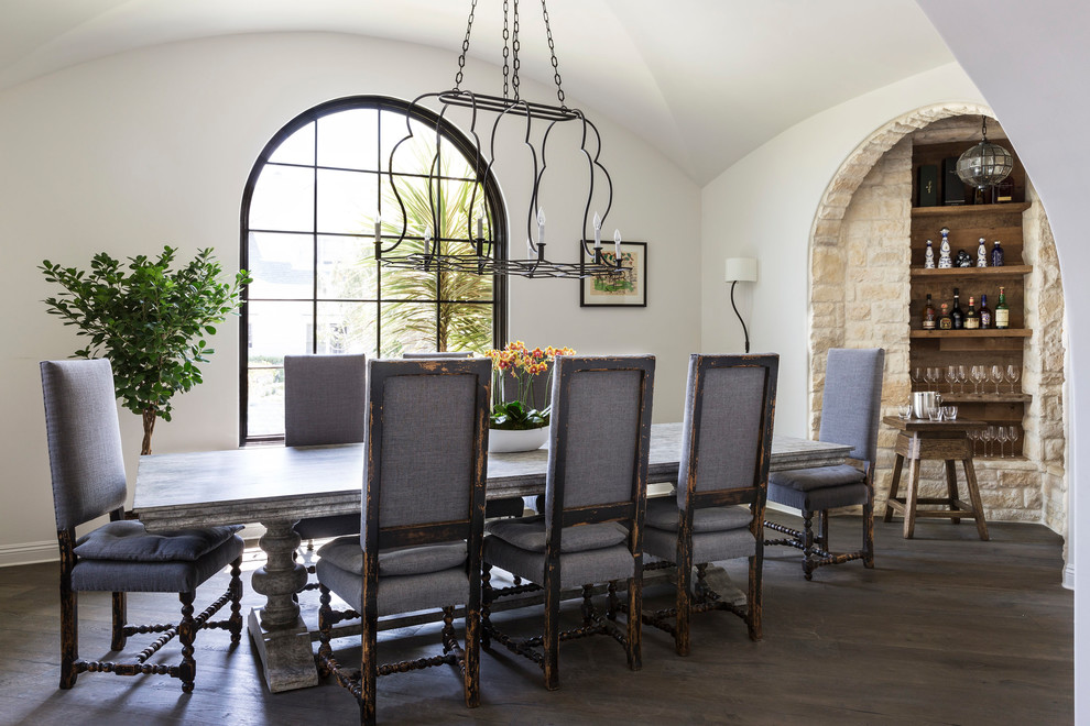 Mediterranean dining room in Other with white walls, dark hardwood floors and no fireplace.
