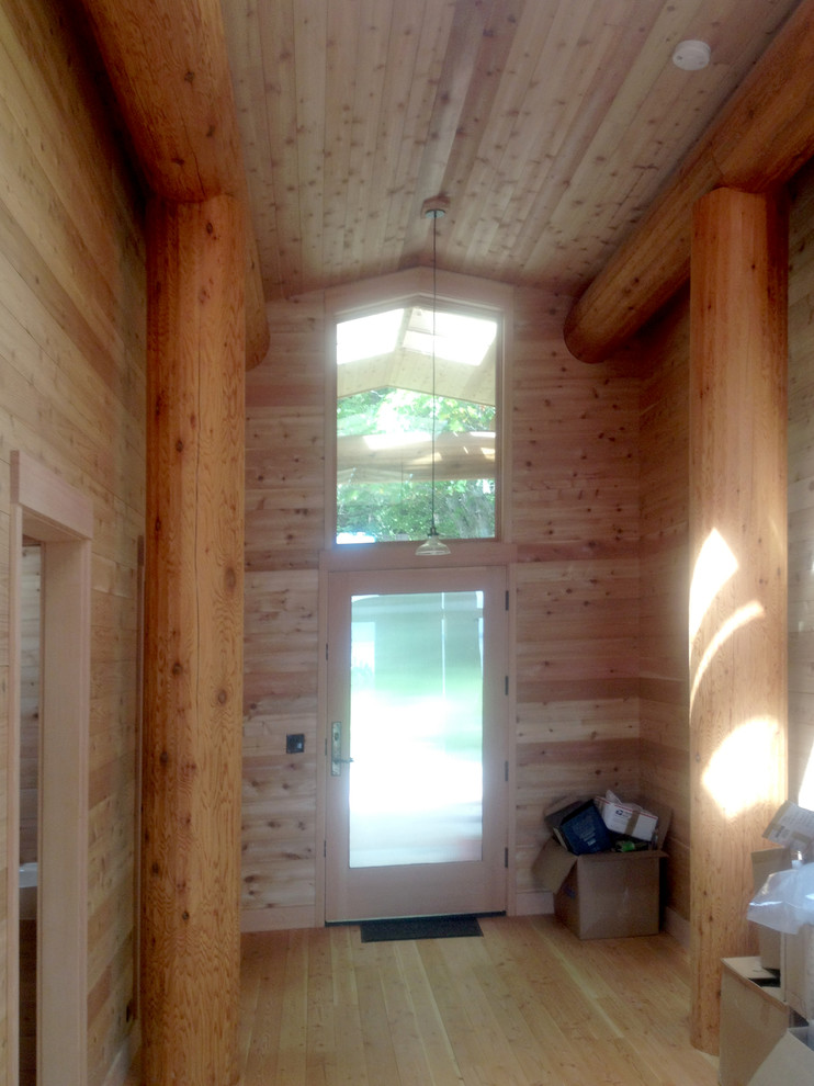 Mountain style light wood floor front door photo in Seattle with a glass front door