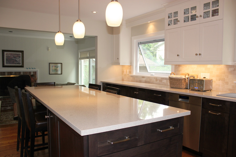 Photo of a large contemporary l-shaped separate kitchen in Ottawa with a double-bowl sink, louvered cabinets, dark wood cabinets, quartzite benchtops, beige splashback, mosaic tile splashback, stainless steel appliances, slate floors and with island.