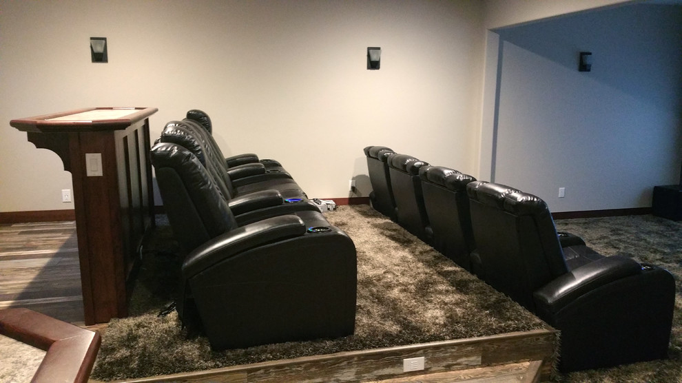 Large contemporary enclosed home theatre in Other with white walls, carpet, a projector screen and grey floor.