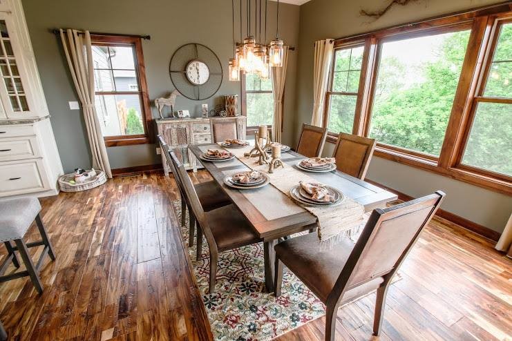 Inspiration for a mid-sized country open plan dining in Milwaukee with multi-coloured walls and medium hardwood floors.