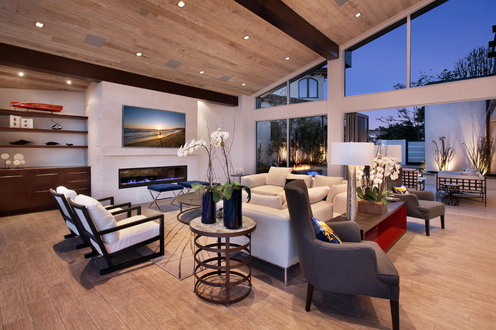 Large contemporary formal open concept living room in Orange County with white walls, medium hardwood floors, a ribbon fireplace, a plaster fireplace surround and no tv.