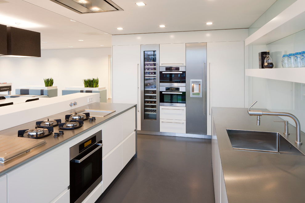 Inspiration for a modern kitchen in New York with an integrated sink and stainless steel benchtops.