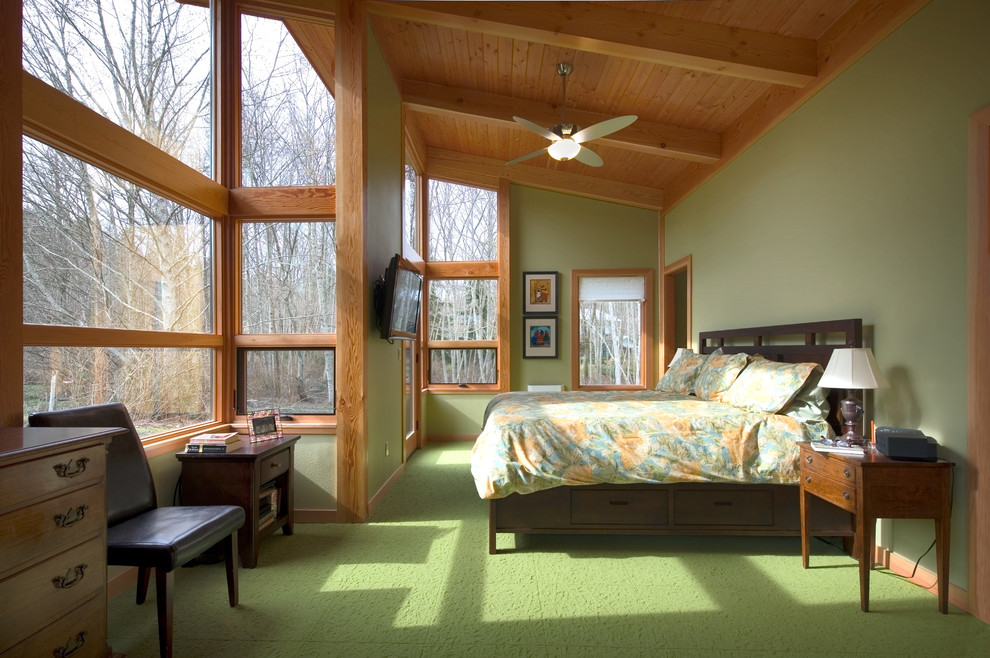 Large contemporary master bedroom in Seattle with green walls, carpet, no fireplace and green floor.