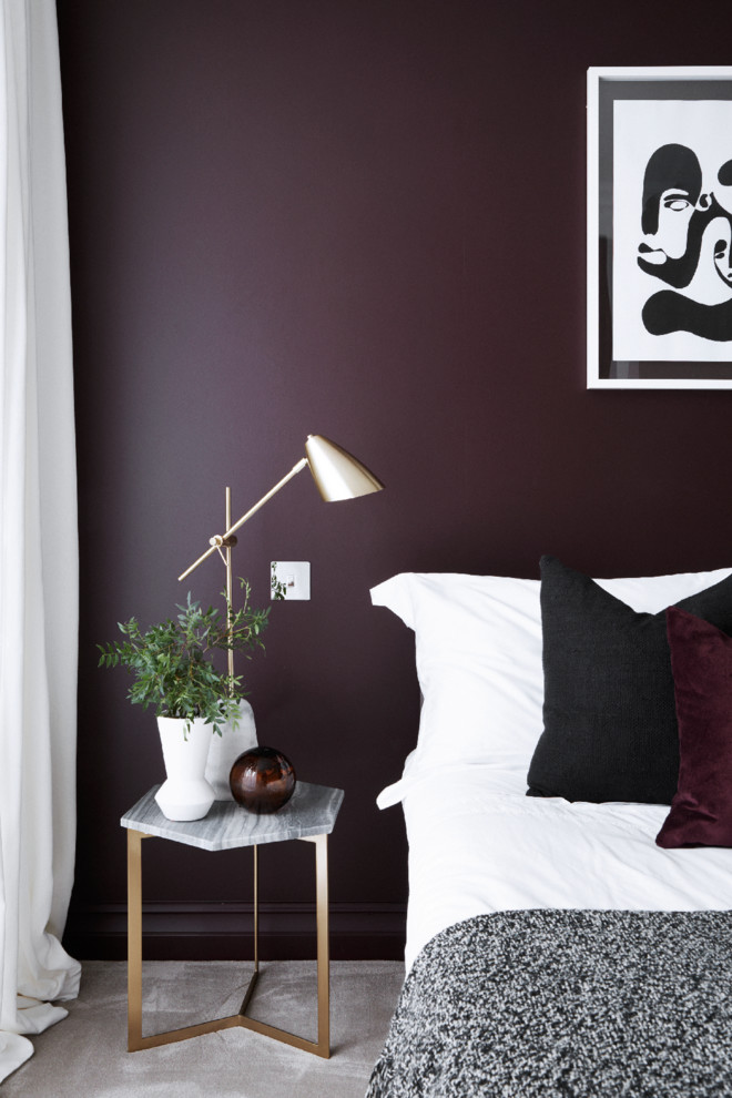 Photo of a mid-sized contemporary master bedroom in London with purple walls, carpet, no fireplace and grey floor.
