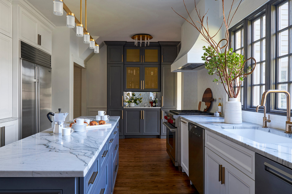 Enclosed kitchen - mid-sized transitional galley medium tone wood floor enclosed kitchen idea in Chicago with a single-bowl sink, recessed-panel cabinets, white cabinets, quartzite countertops, white backsplash, ceramic backsplash, stainless steel appliances, an island and white countertops