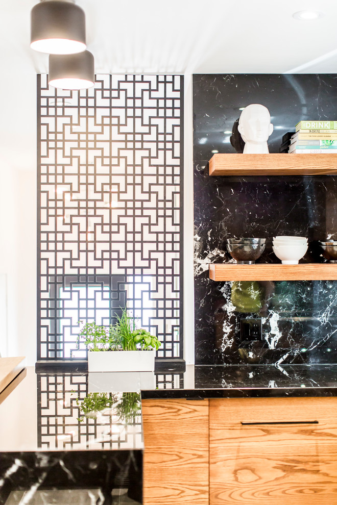 Mid-sized asian u-shaped kitchen pantry in Toronto with an undermount sink, flat-panel cabinets, medium wood cabinets, marble benchtops, black splashback, marble splashback, stainless steel appliances, concrete floors, with island and grey floor.