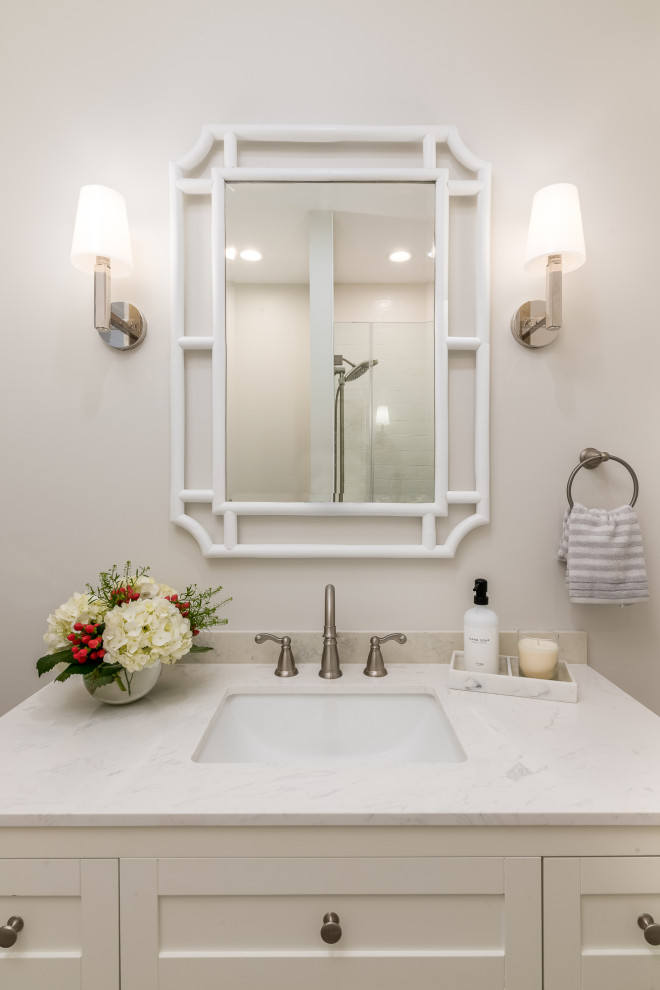 ニューヨークにある高級な中くらいなトランジショナルスタイルのおしゃれな浴室 (シェーカースタイル扉のキャビネット、白いキャビネット、アルコーブ型シャワー、一体型トイレ	、白いタイル、セラミックタイル、白い壁、セラミックタイルの床、アンダーカウンター洗面器、クオーツストーンの洗面台、グレーの床、開き戸のシャワー、白い洗面カウンター、洗面台1つ、独立型洗面台) の写真
