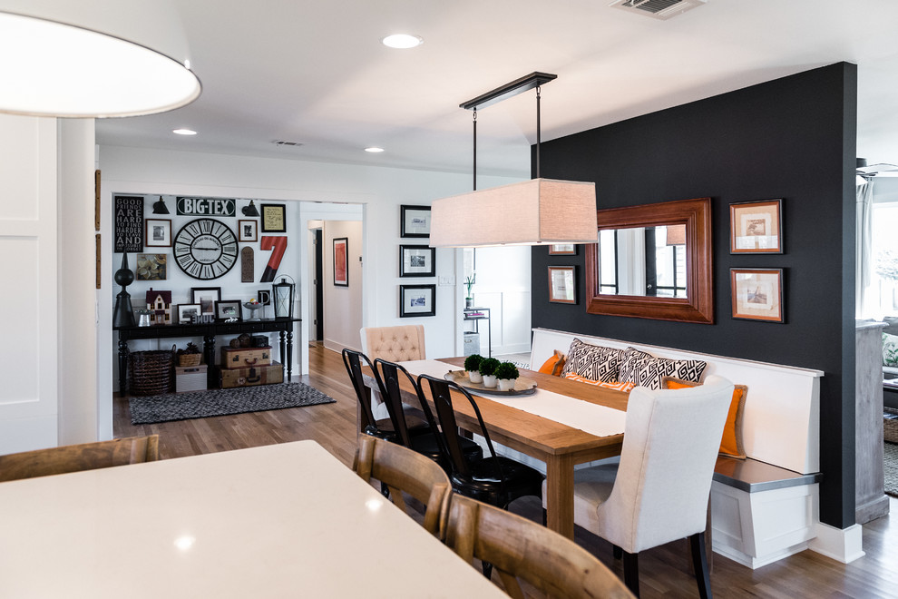 Photo of a large transitional kitchen/dining combo in Austin with black walls, medium hardwood floors and no fireplace.