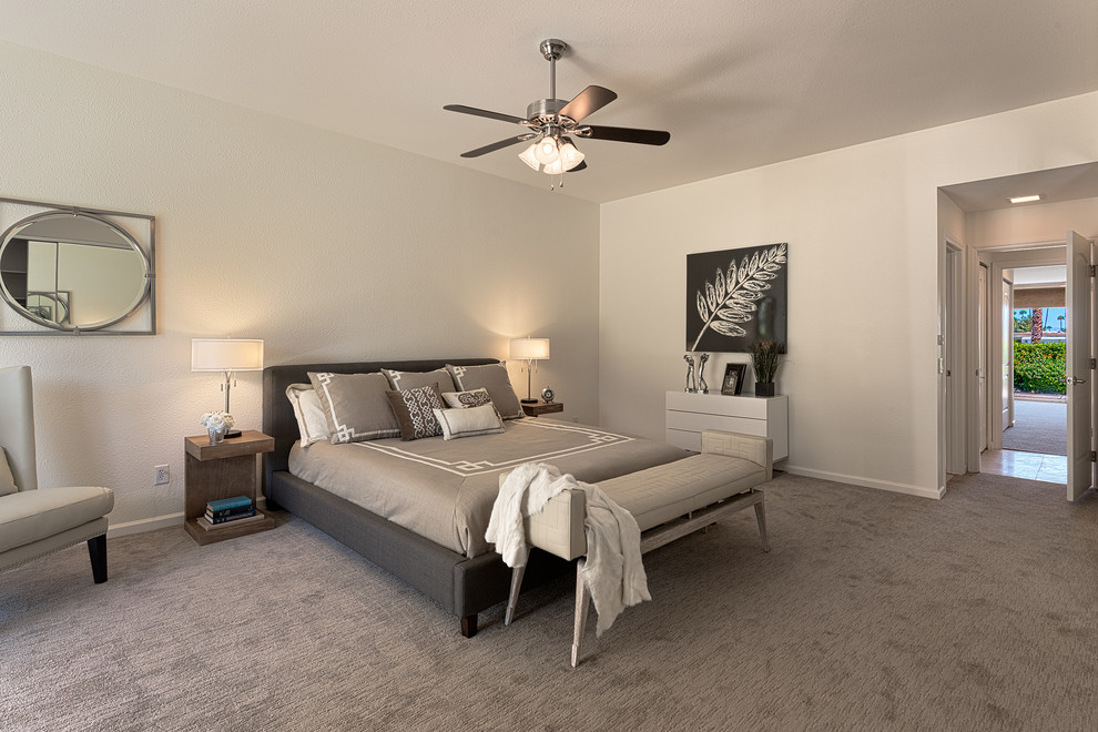 This is an example of a large midcentury master bedroom in Other with beige walls and carpet.