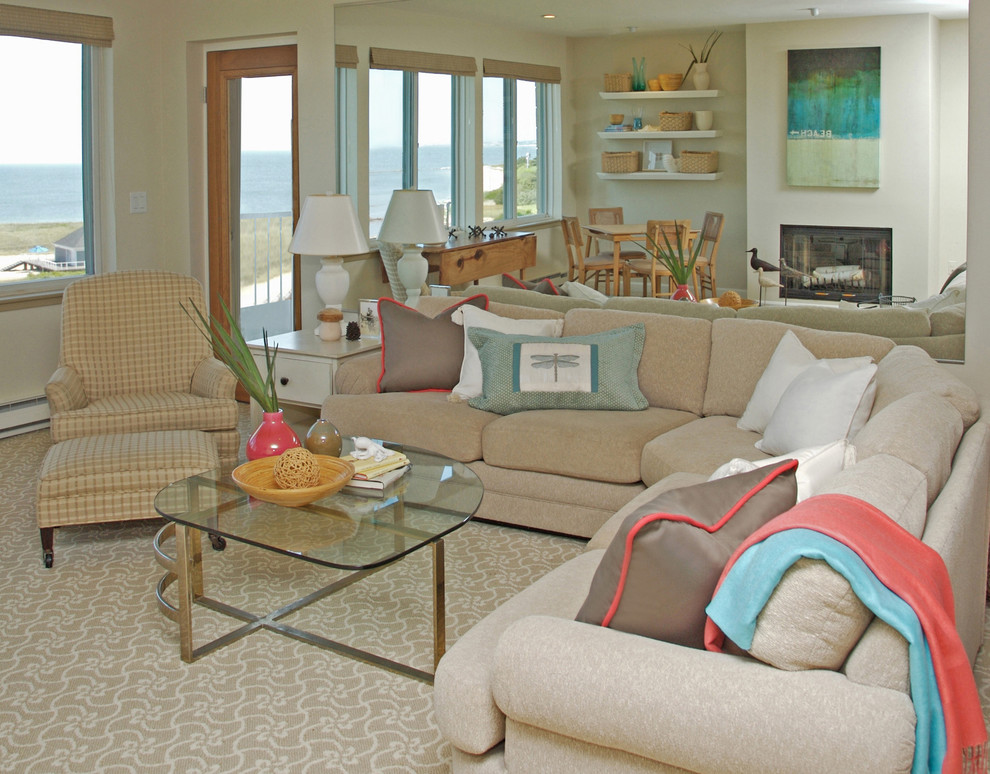 Inspiration for a mid-sized beach style open concept living room in Other with a standard fireplace, carpet, beige floor and grey walls.