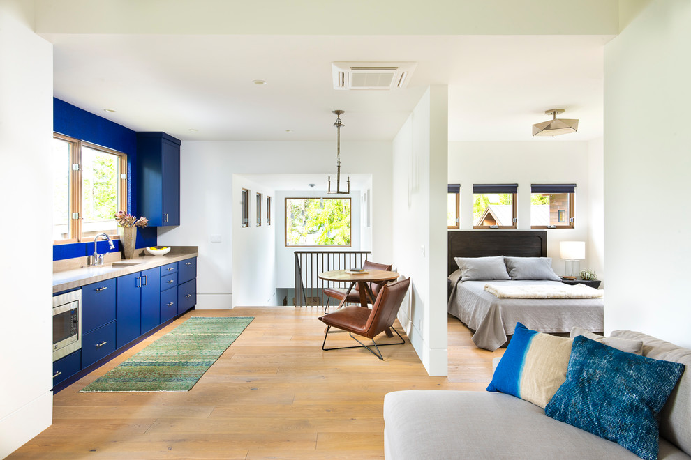 Lakeside Retreat - Trendy medium tone wood floor and brown floor bedroom photo with white walls