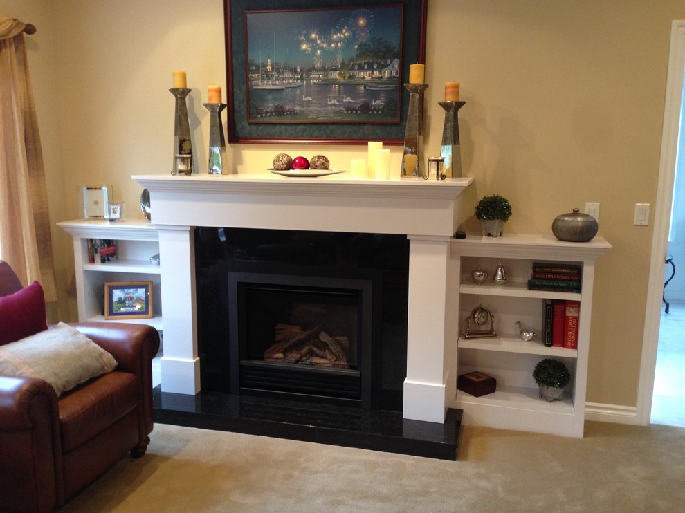 Photo of a contemporary living room in Vancouver with a stone fireplace surround and a standard fireplace.