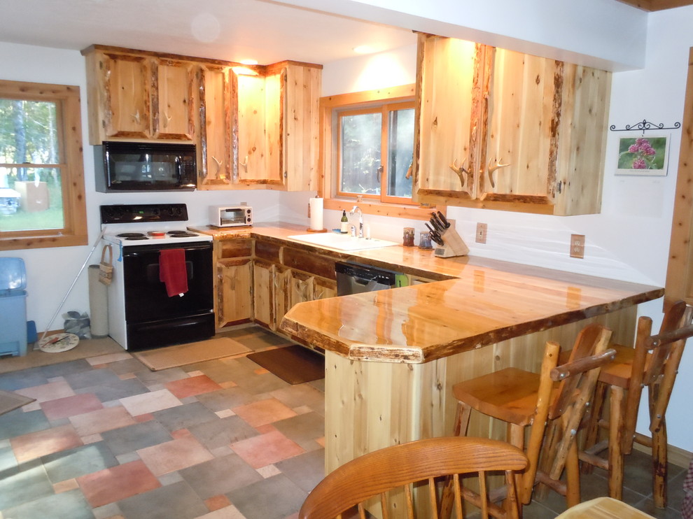 Mountain style eat-in kitchen photo with medium tone wood cabinets