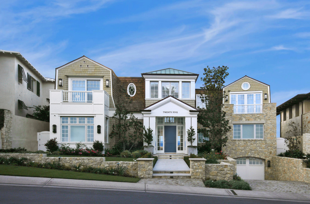 Beach style two-storey brown house exterior in Orange County with mixed siding, a gable roof and a mixed roof.