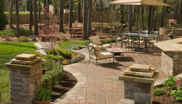 Design ideas for a large traditional backyard verandah in Raleigh with brick pavers.