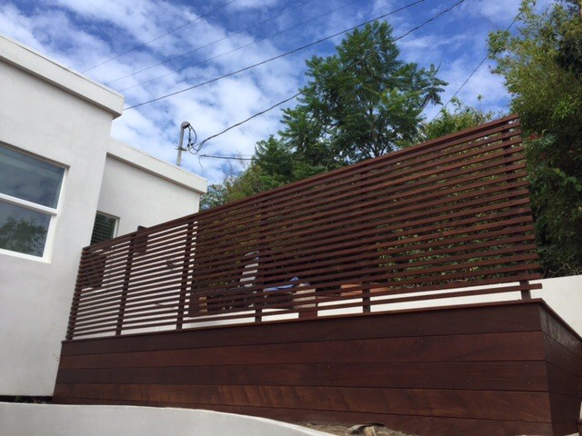 Inspiration for a large modern backyard deck in Los Angeles with a roof extension.