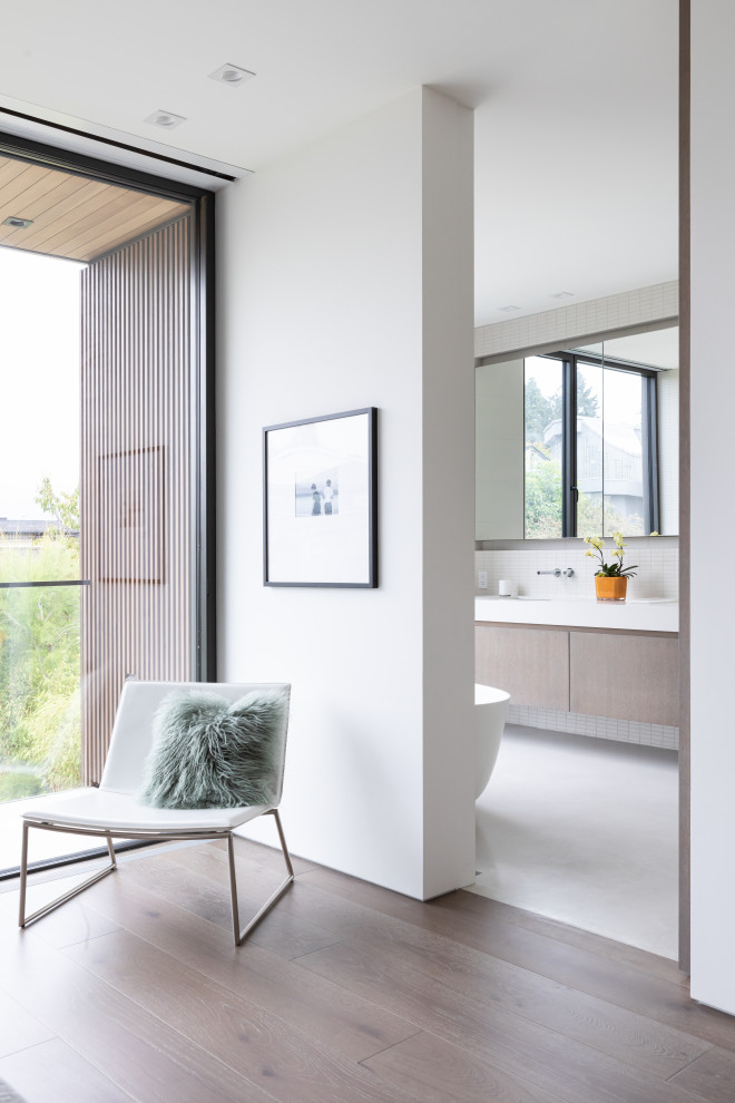 Mid-sized contemporary master bathroom in Vancouver with flat-panel cabinets, medium wood cabinets, a freestanding tub, a curbless shower, white tile, matchstick tile, white walls, concrete floors, an undermount sink, quartzite benchtops, grey floor, a hinged shower door, white benchtops, a double vanity and a floating vanity.