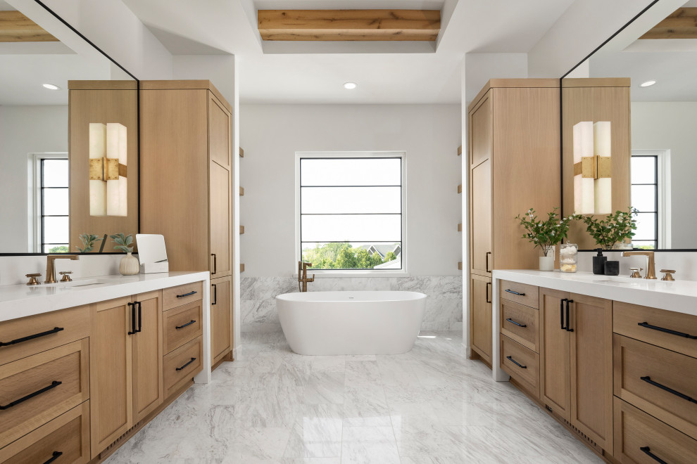 Transitional master marble floor, multicolored floor, double-sink and exposed beam freestanding bathtub photo in Minneapolis with shaker cabinets, medium tone wood cabinets, white walls, an undermount sink, quartz countertops, white countertops and a built-in vanity