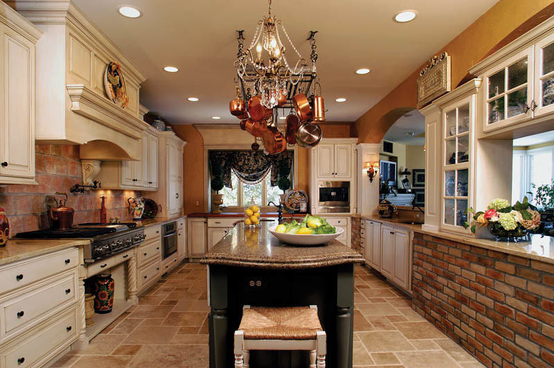 Inspiration for a transitional eat-in kitchen remodel in Indianapolis with white cabinets, granite countertops, multicolored backsplash, stainless steel appliances and an island