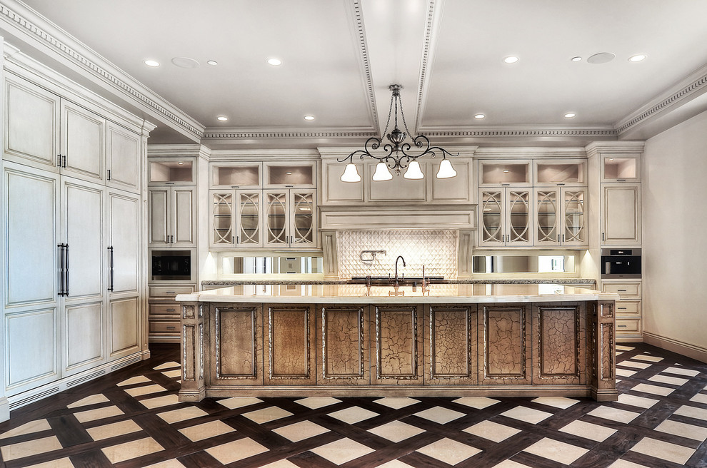 Design ideas for a large traditional eat-in kitchen in Orange County with raised-panel cabinets, white cabinets, granite benchtops, white splashback, dark hardwood floors and with island.