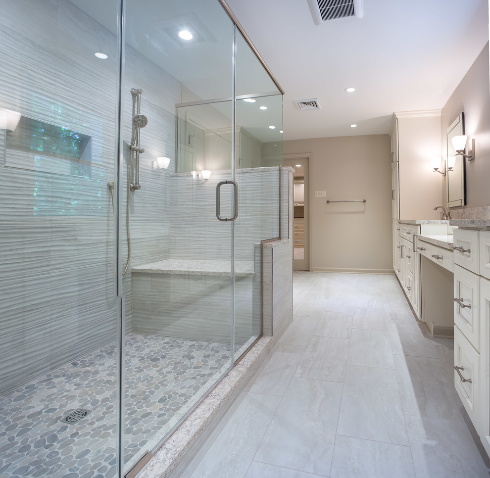 Design ideas for a contemporary master bathroom in Wilmington with recessed-panel cabinets, beige cabinets, a double shower, a one-piece toilet, beige tile, beige walls, ceramic floors, an undermount sink, engineered quartz benchtops and a hinged shower door.