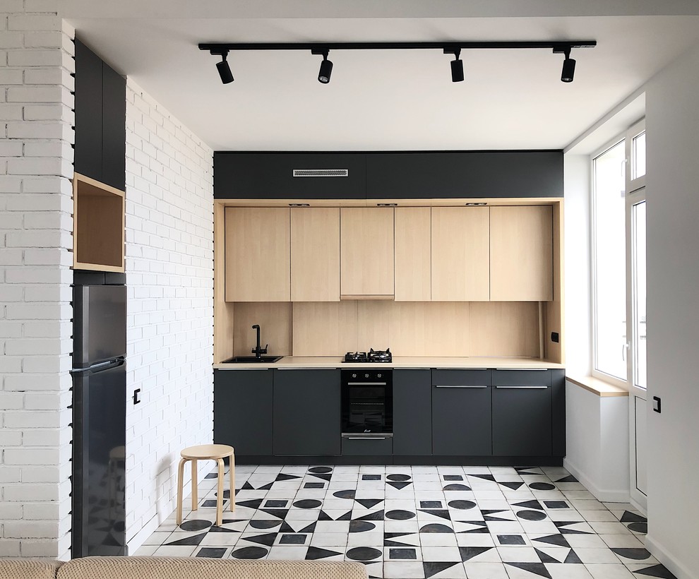 Inspiration for a mid-sized contemporary single-wall open plan kitchen in Other with flat-panel cabinets, grey cabinets, laminate benchtops, beige splashback, timber splashback, black appliances, porcelain floors, beige benchtop, a drop-in sink, no island and white floor.