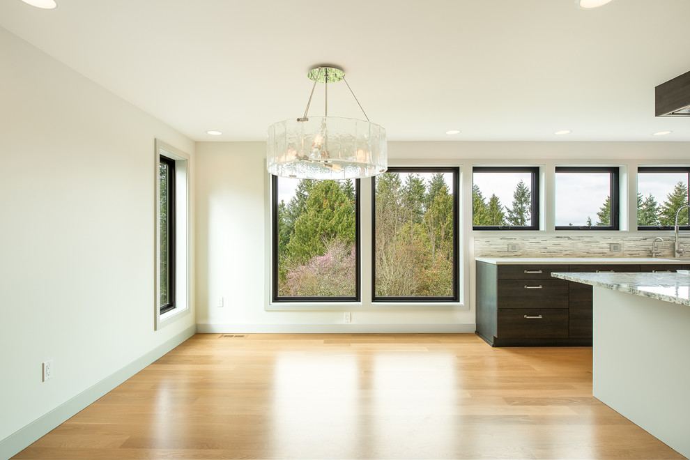 Mid-sized transitional light wood floor and beige floor kitchen/dining room combo photo in Seattle with white walls and no fireplace